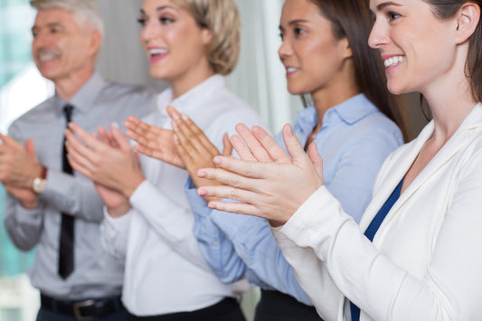 Quattro persone applaudono approvandone un'altra fuori campo